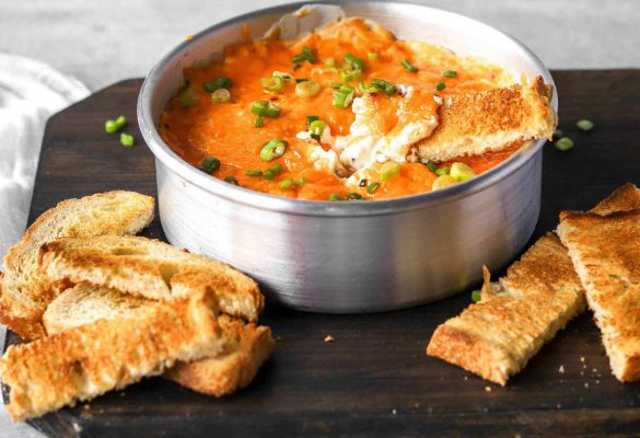 Loaded Cream Cheese Dip in a bow with bread on the side